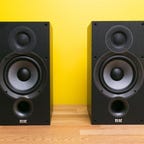 A pair of black ELAC Debut 2.0 B6.2 bookshelf speakers