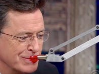 <p>"The Late Show" host Stephen Colbert tries out Simone Giertz's lipstick robot.</p>