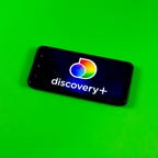 Discovery Plus logo on a phone