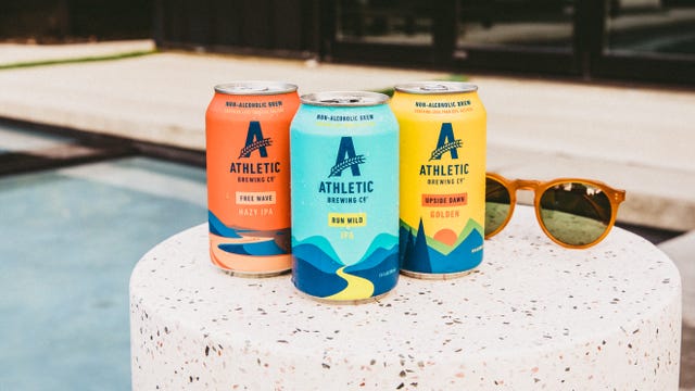 athletic brewing cans by the pool