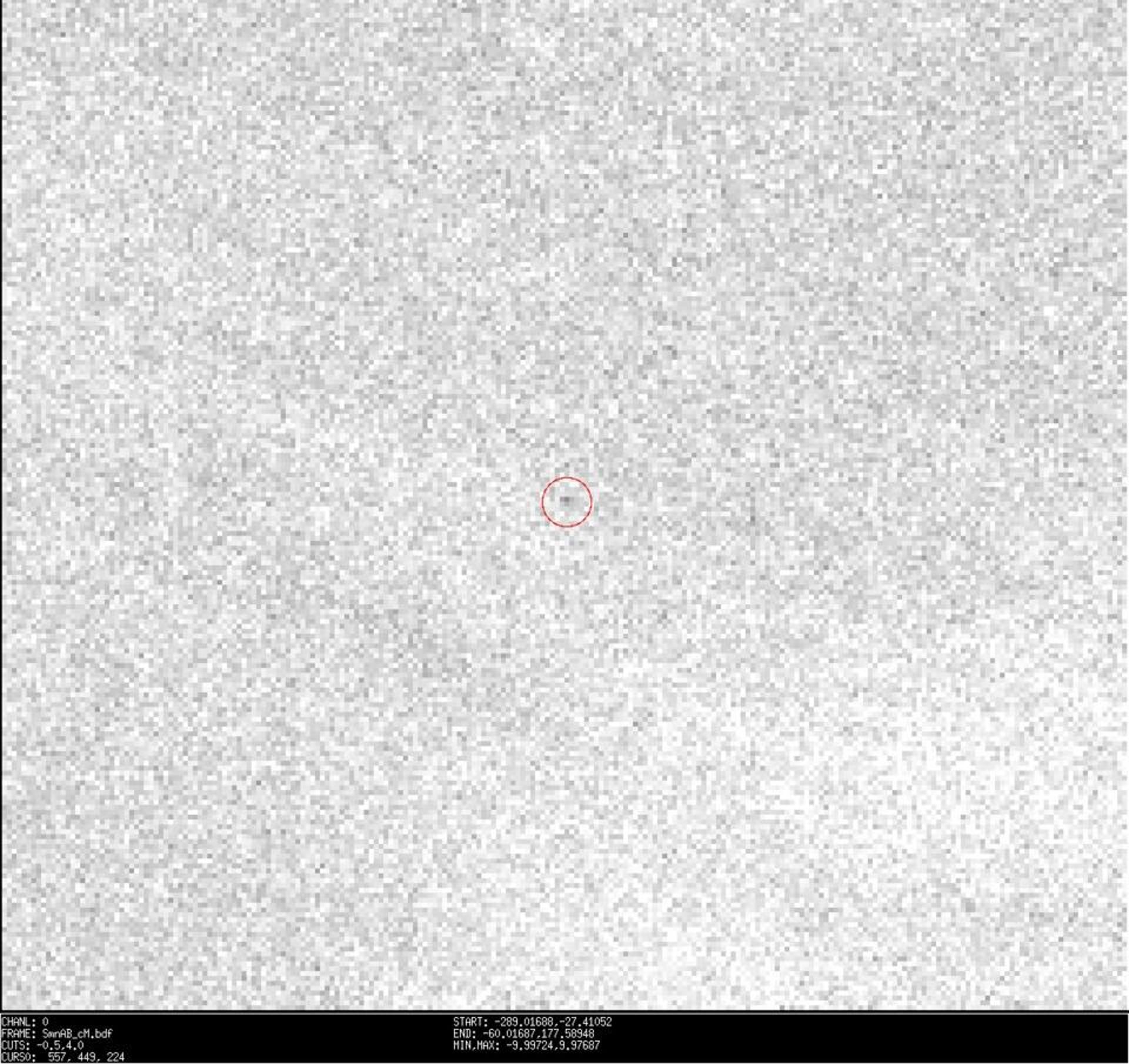 Asteroid 2021 QM1 is circled in red against a blurry pixelated gray backdrop.