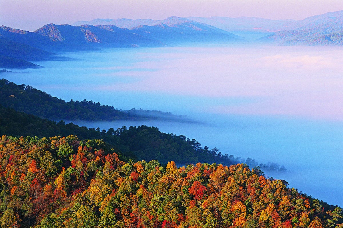 Cumberland Gap in Kentucky, featuring fall foliage and mist over the mountains.