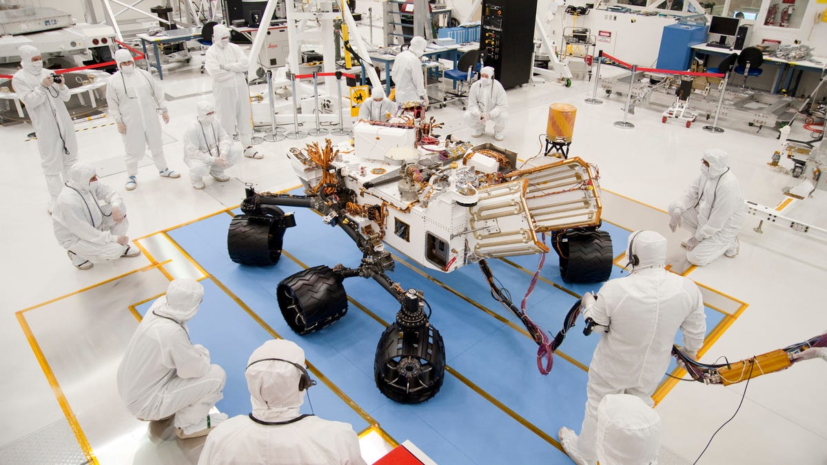 NASA&apos;s next Mars rover, Curiosity, takes its first, brief test drive in a Jet Propulsion Lab clean room on July 23.