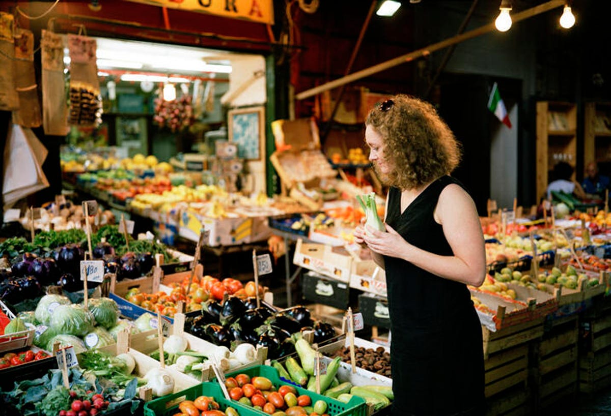 middle-aged woman at a produce stand