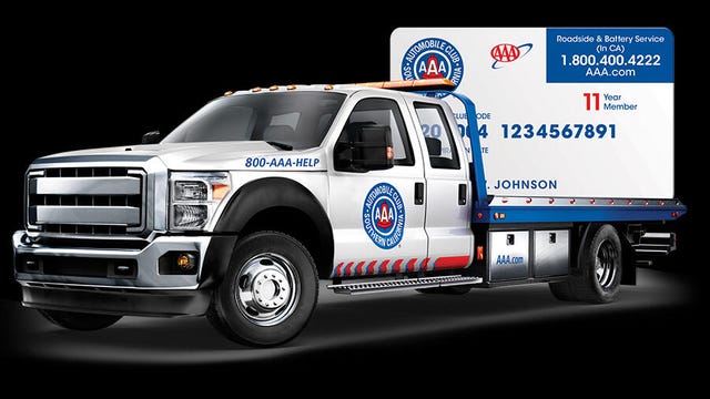 A AAA tow truck with an oversized AAA membership card in the back.