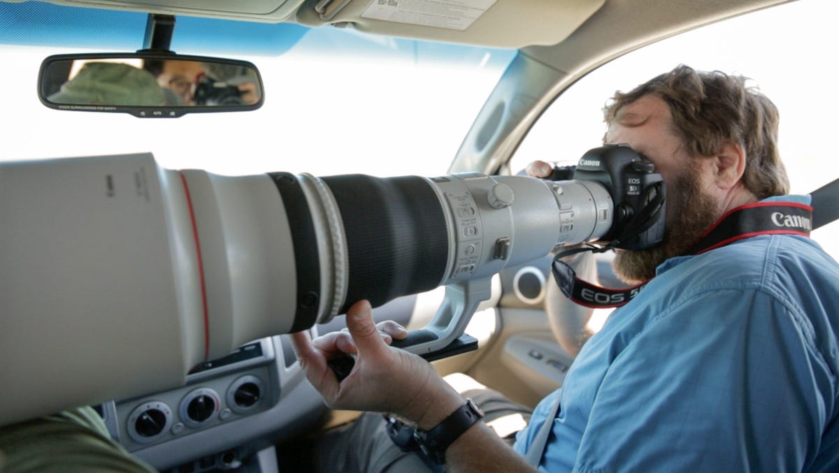 Cars make a good hide, a secluded spot to photograph birds without spooking them. CNET's Stephen Shankland and a 600mm Canon lens here takes up most of the front seat in Point Reyes National Seashore, California.