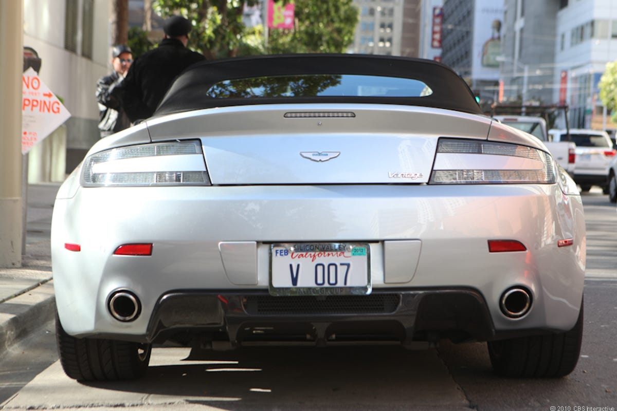 The flashy Aston Martin's license plate reads 