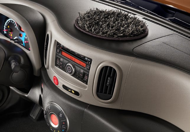 The dash-topping shag rug is one way drivers can personalize the Cube. But don't expect to get any use out of it.