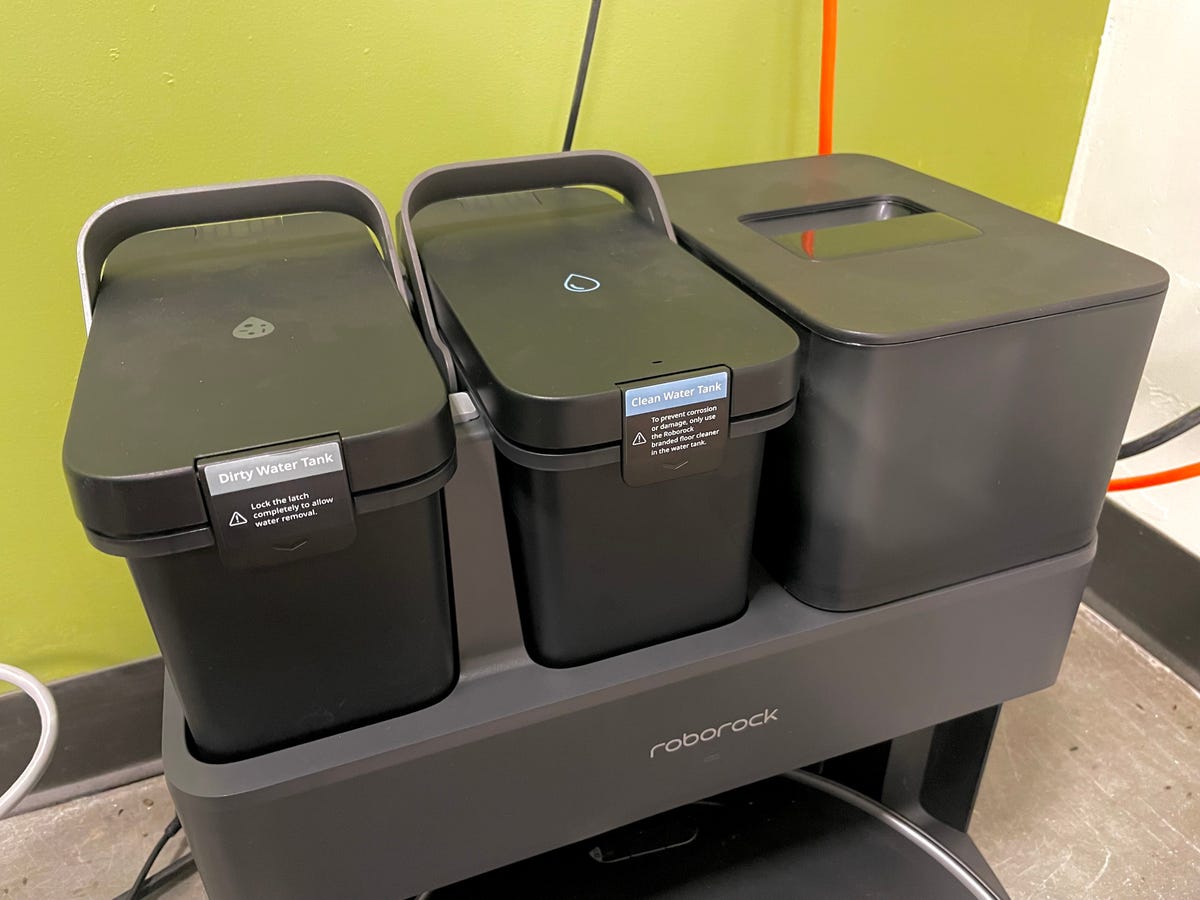 Three reservoirs sit atop the dock for the Roborock S7 MaxV Ultra robot floor cleaner: a tank for fresh water or cleaning solution, a tank for dirty water or cleaning solution, and a compartment for the vacuum bags into which the cleaner will automatically empty the dirt and debris it picks up.