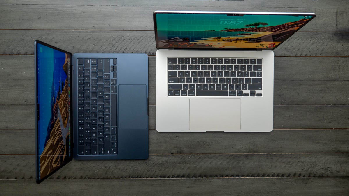 Apple MacBook Air M3 13-inch and 15-inch laptops on a wood table.