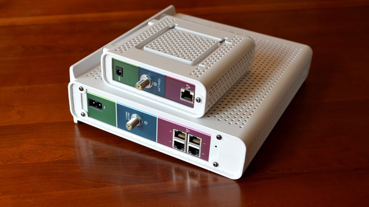 a standalone cable modem sits on top of the much larger SURFboard eXtreme combo device