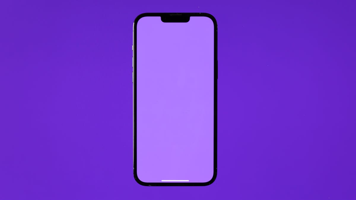 A purple iPhone against a purple background