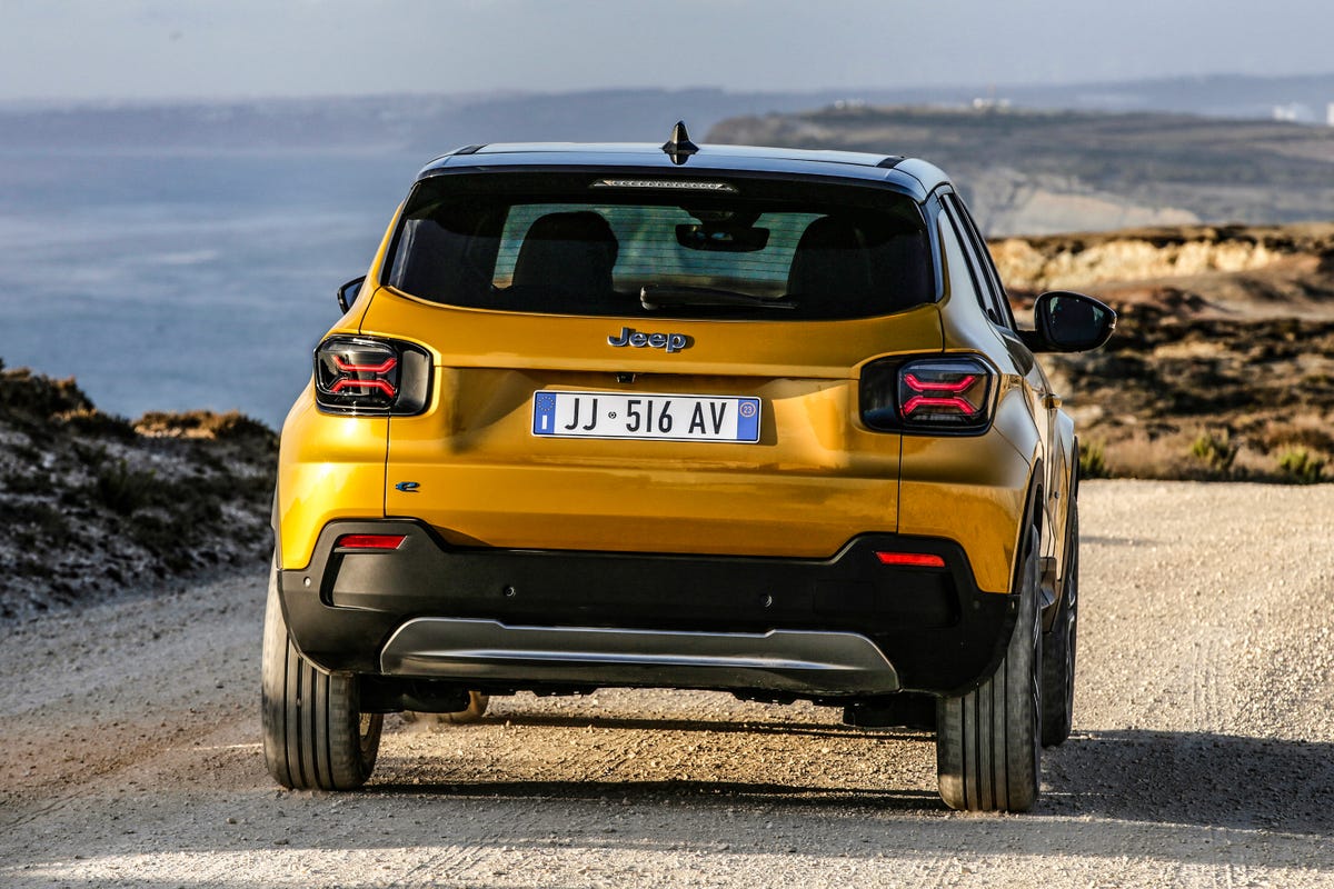 Rear view of the 2023 Jeep Avenger EV on a shore drive