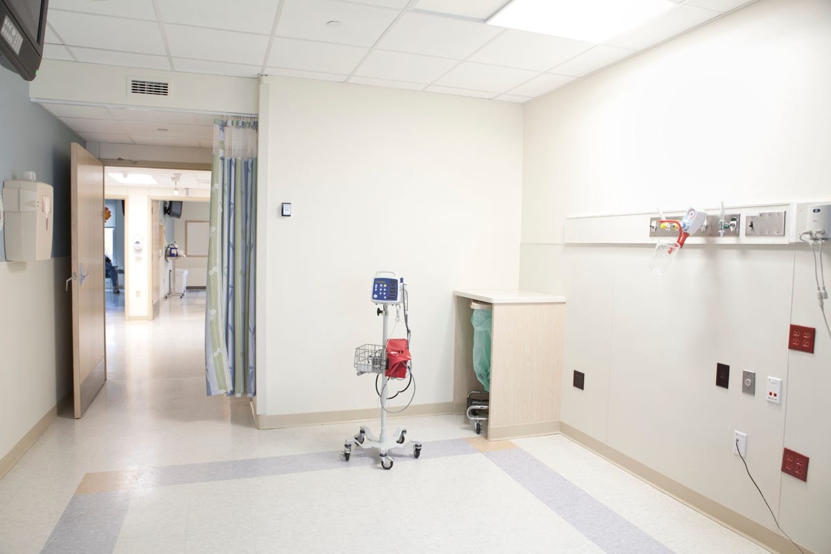 An empty hospital room with monitoring equipment