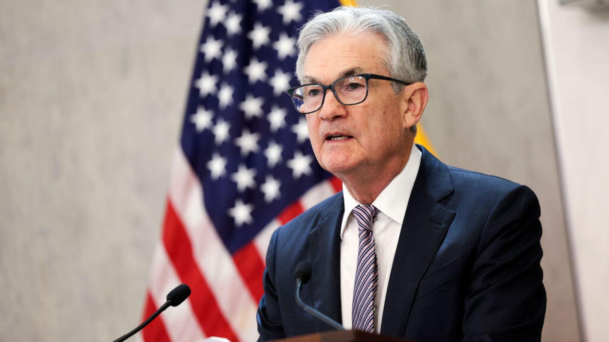 Jerome Powell in front of an American flag at a press briefing