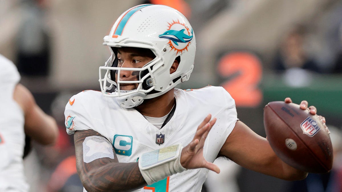 Tua Tagovailoa of the Miami Dolphins preparing to throw a ball with his left hand.