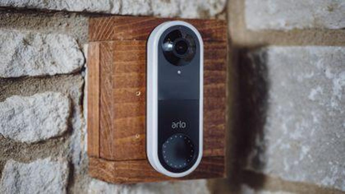 An Arlo video doorbell mounted on the exterior of a home.
