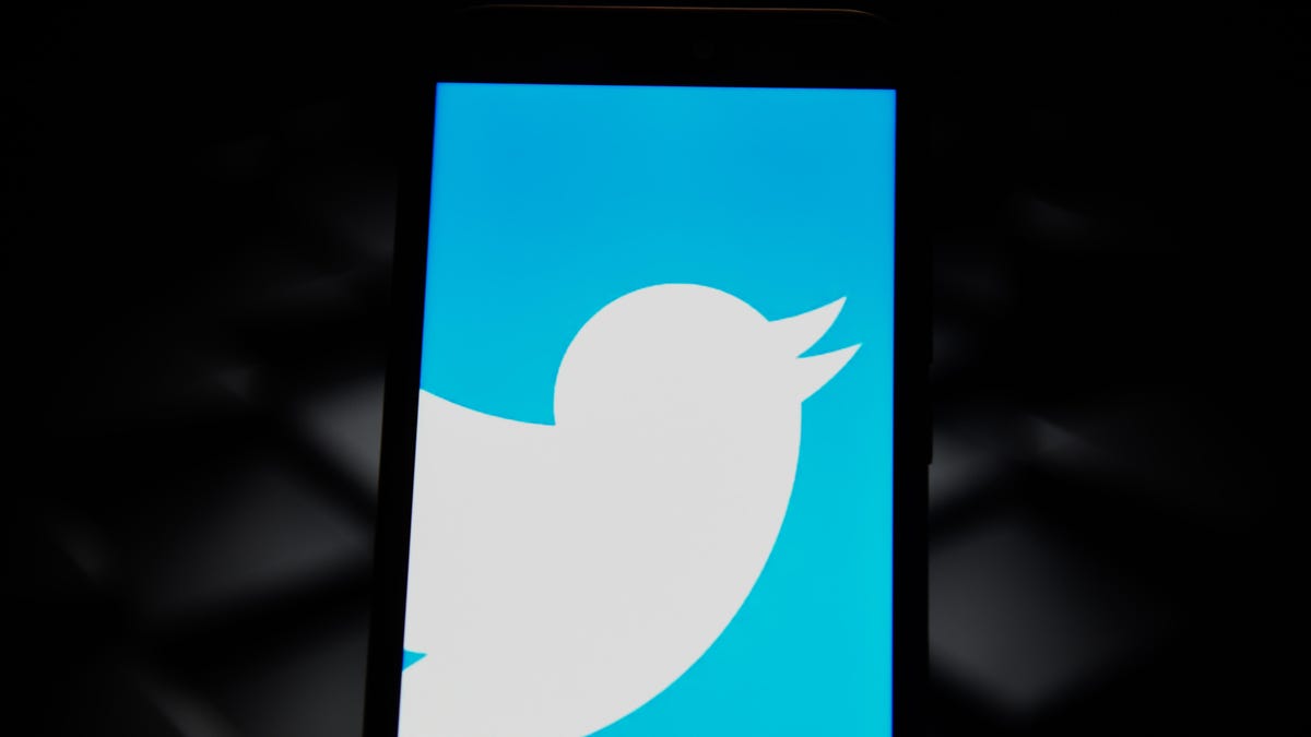 In this photo illustration a Twitter logo seen displayed on