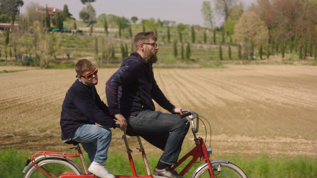 Brothers Lorenzo and Giovanni Caggioni ride a tandem bike.