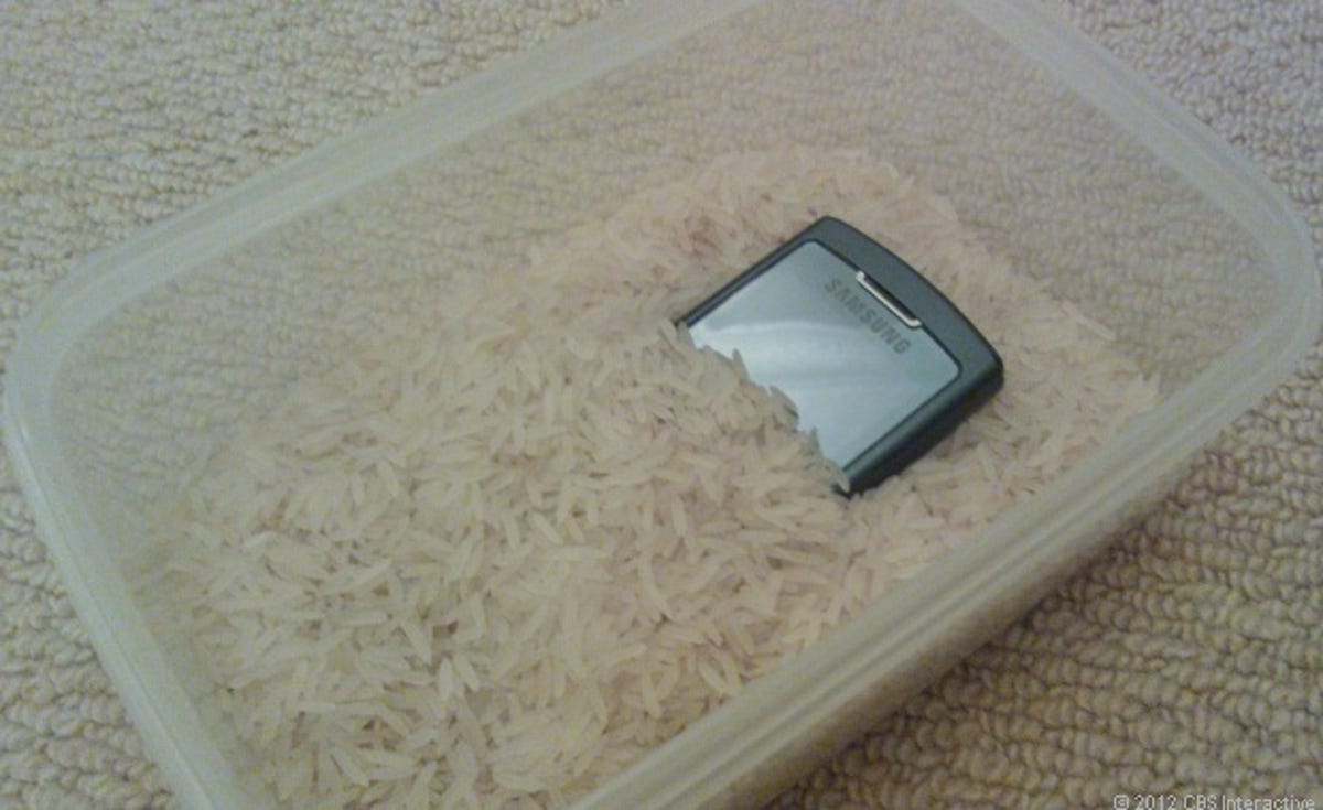 Phone buried in rice.