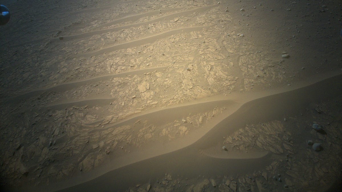 Processed Ingenuity color camera image shows network of sandy dunes reaching across a rocky landscape.