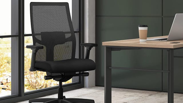 Office chair next to desk with coffee on.