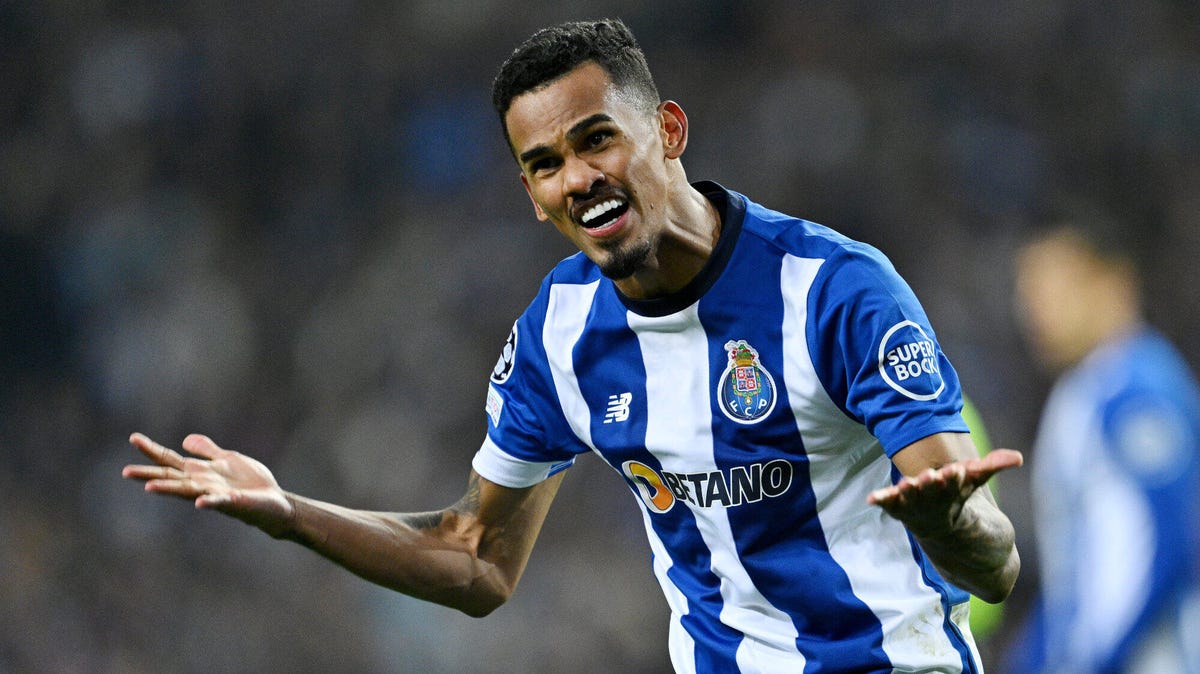 FC Porto winger Galeno smiling, celebrating, with both hands held out, open.