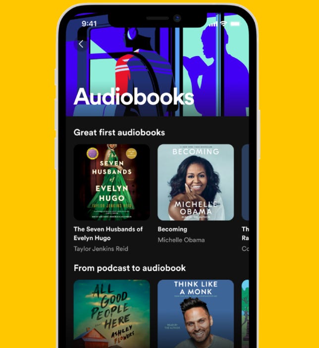 A phone shows Spotify's new audiobooks hub.
