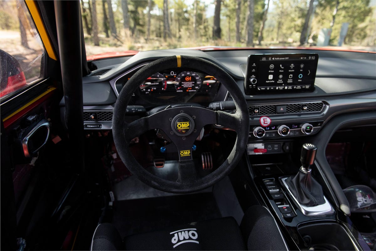 The interior of the Acura Integra Pikes Peak, showing an OMP steering wheel and seats, but otherwise mostly stock.