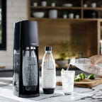SodaStream Terra soda water maker with bottles and water glass