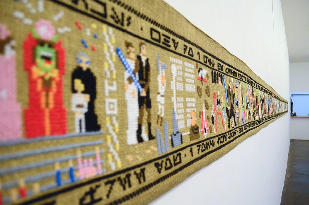 Artist Aled Lewis even translated quotes from each movie into the fictional "Star Wars" language of Aurebesh on the border of the tapestry.