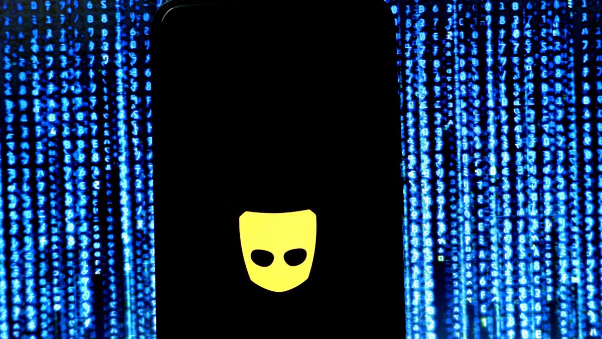 The Grindr logo on a phone screen against a blue background