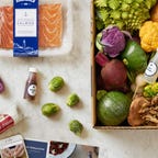 Assorted meal kit ingredients including salmon and vegetables