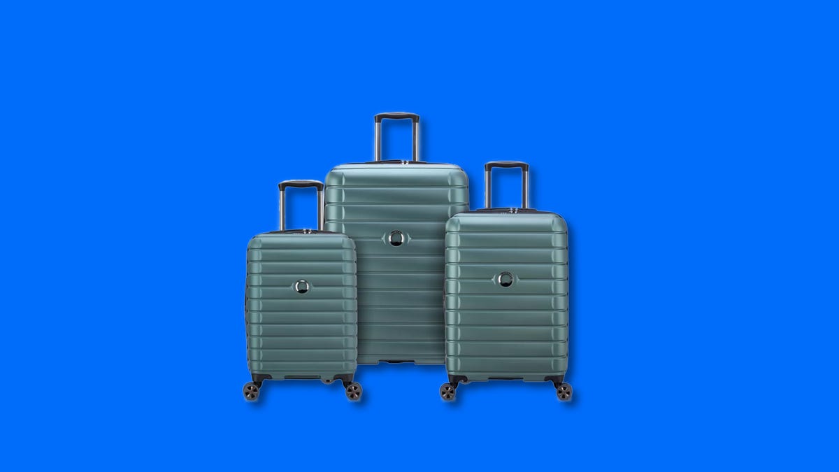 Three different sizes of green luggage on a blue background
