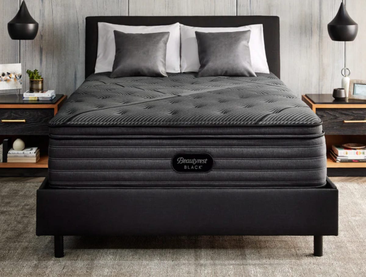 The premium Beautyrest Black mattress on a large black bed frame