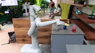 A Google robot grasps a Pepsi can with its articulated mechanical arm