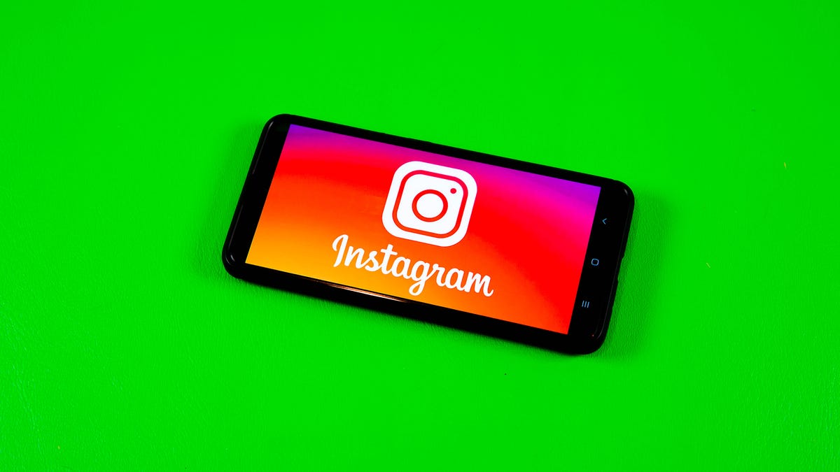 Instagram logo on smartphone on green background