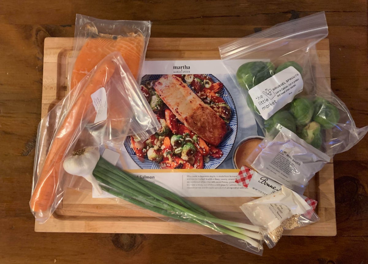Various elements of a meal kit on a cutting board