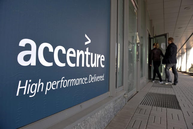 People enter an Accenture office in down