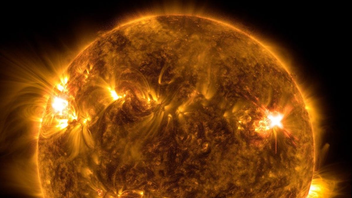 Partial SDO view of the sun shows swirling masses of light and a very bright flare on one side.