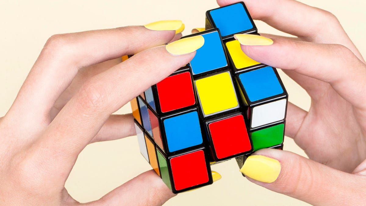Close-up of woman&apos;s hand with Rubik&apos;s Cube