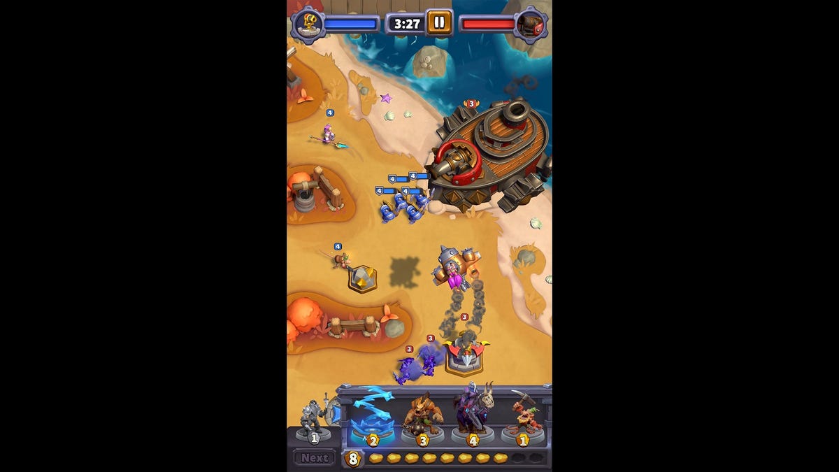 A vertical screenshot of minions headed down three lanes to face a colossal Ogre Juggernaut battleship boss, which has been firing cannonballs at the player's units through the match.