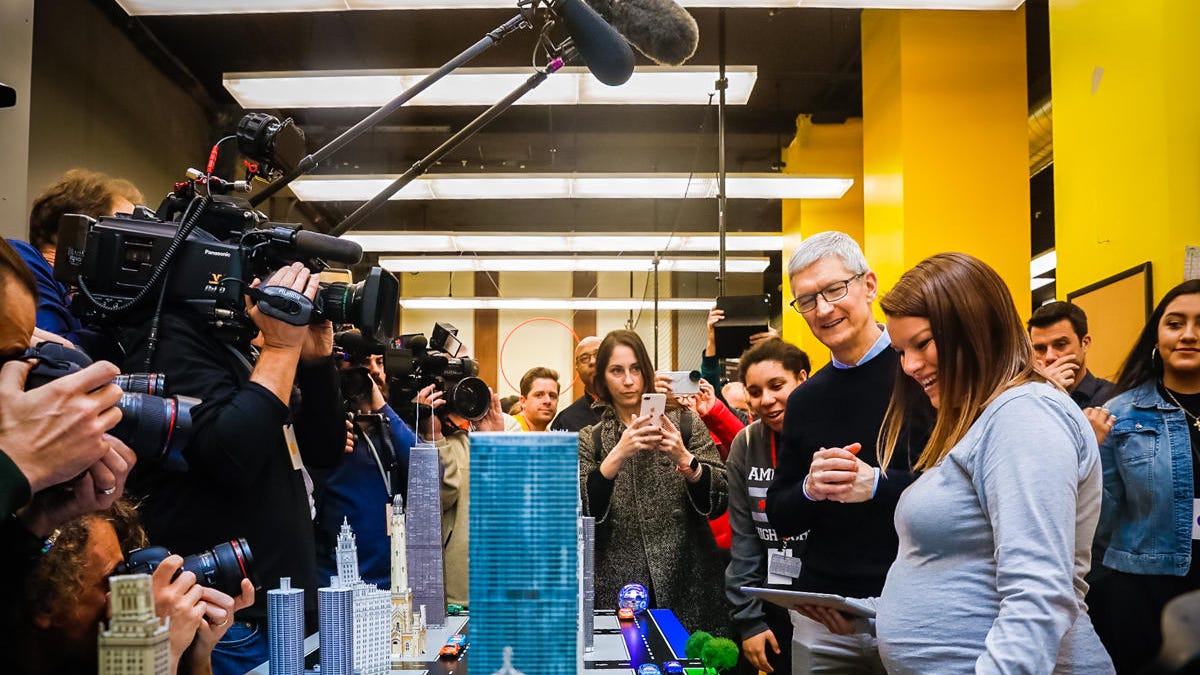 Apple CEO Tim Cook checks out one of the demos at the company&apos;s education event in Chicago.
