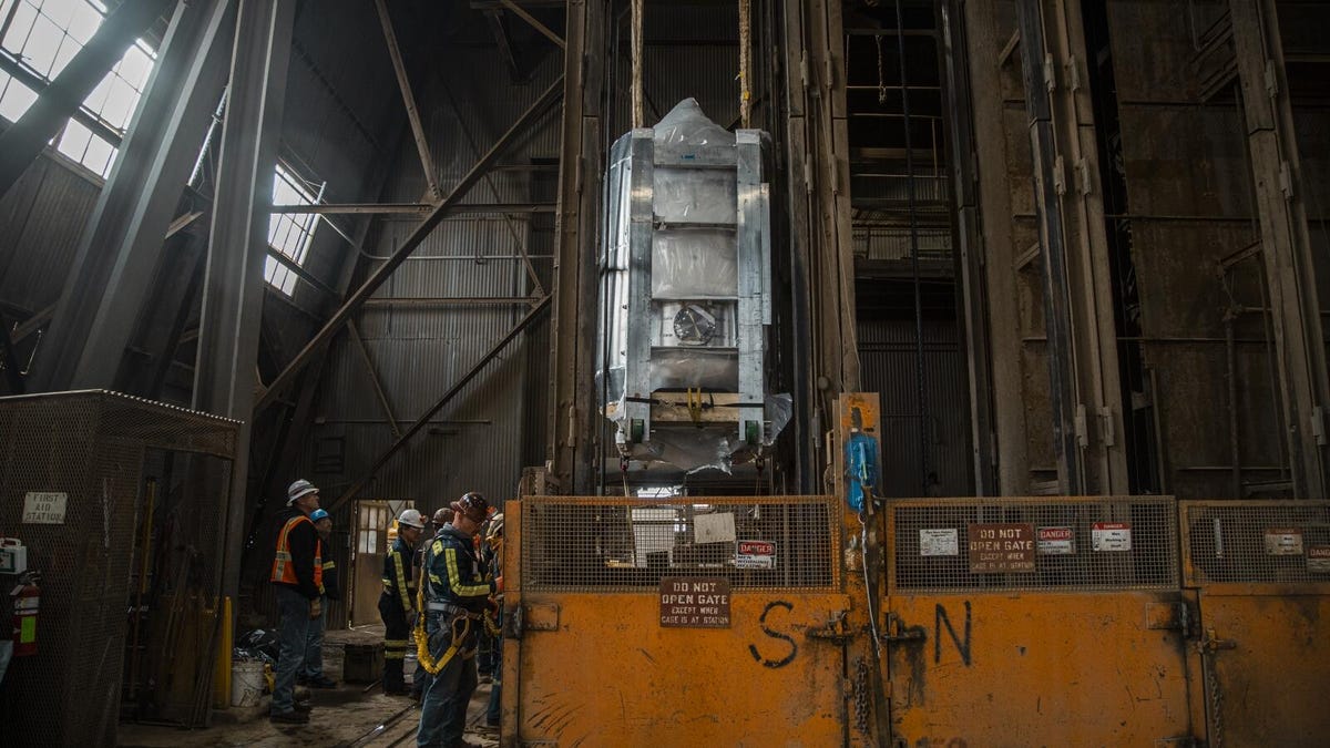 An image of an elevator shaft bringing the cylindrical machine deep underground.