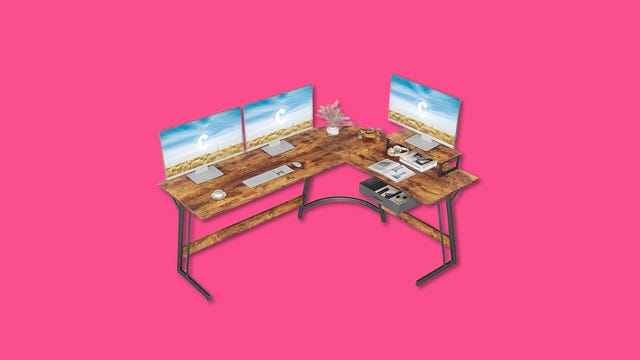 Wooden topped L shaped desk with three monitors