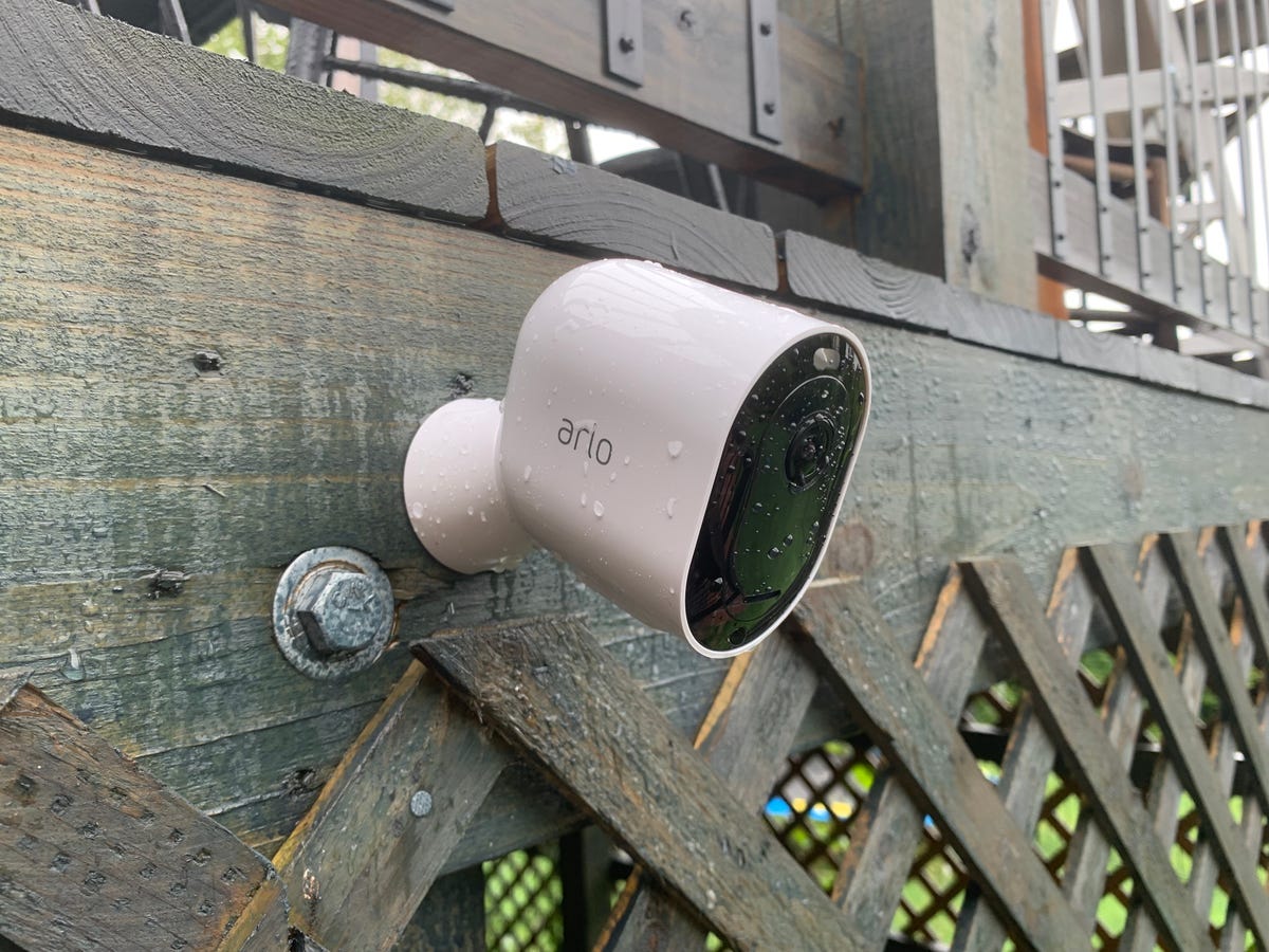 The Arlo Pro 4 outdoor security camera mounted to the exterior of a home's porch.