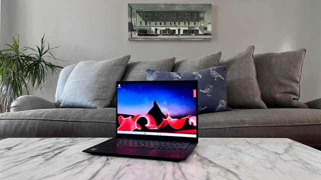 Lenovo ThinkPad X1 Carbon Gen 11 laptop on a coffee table in front of a couch