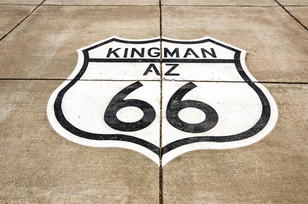 Painted sign on concrete in Kingman, Arizona, on Route 66.