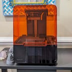 The Formlabs form 3 plus on a table with 3d printed models next to it