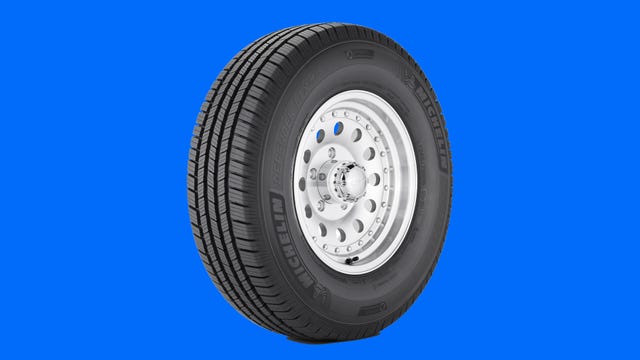 The Michelin Defender LTX M/S tire is shown on a blue background